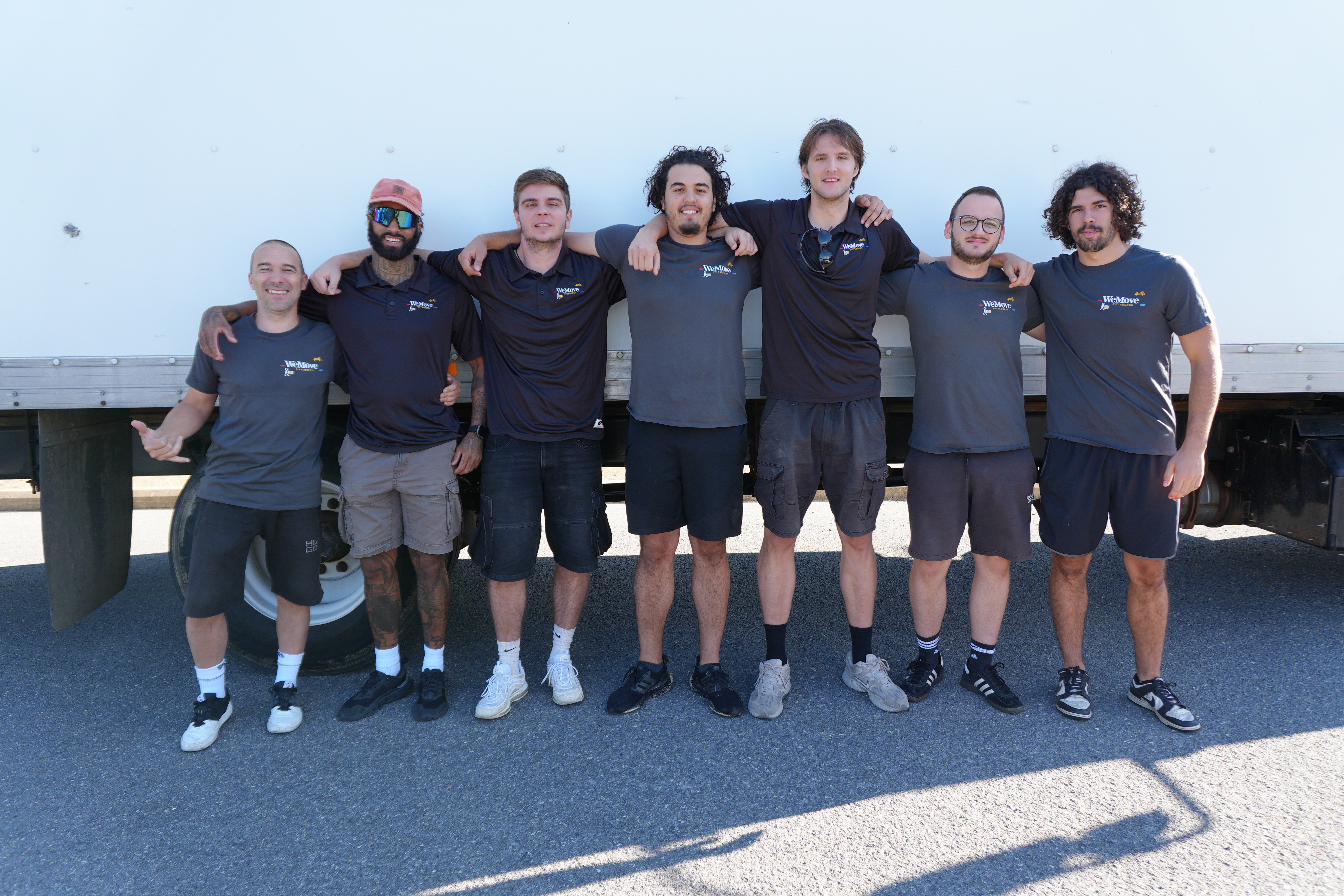 The full WeMove Pittsburgh crew standing together in front of the moving truck